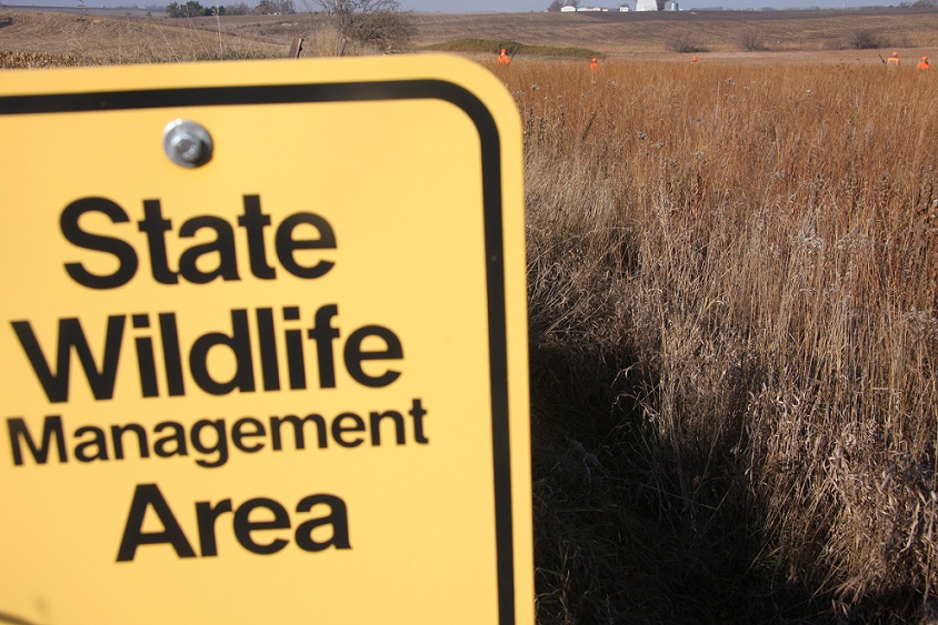 Wildlife management sign in field