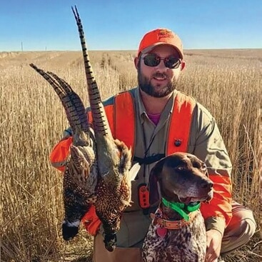 Andy Houser with dog and pheasant